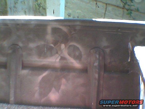 Undercarriage part with visible rust and some discoloration